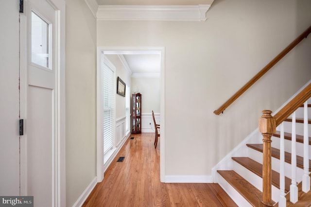 interior space featuring wood-type flooring and ornamental molding