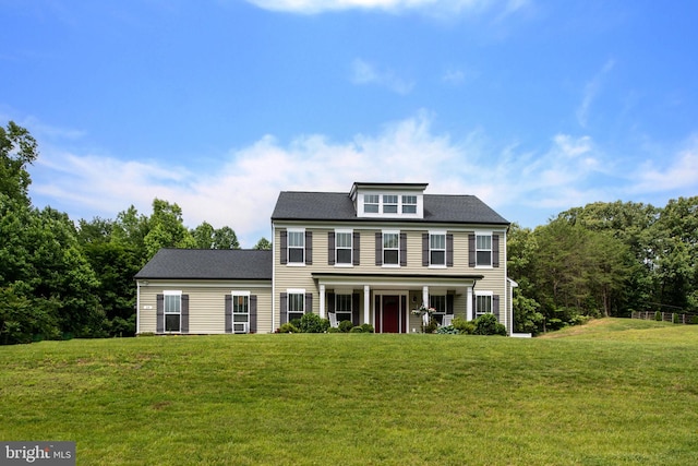 colonial inspired home with a front lawn