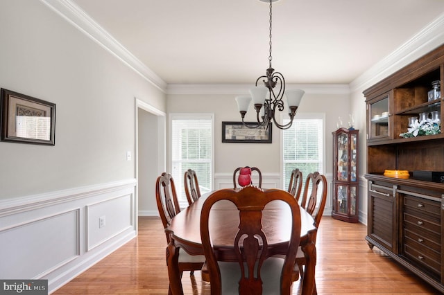 dining room featuring light hardwood / wood-style floors, plenty of natural light, and ornamental molding