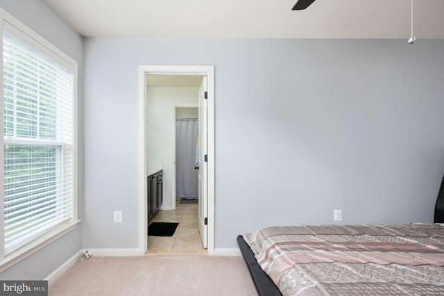 bedroom featuring light carpet and ceiling fan