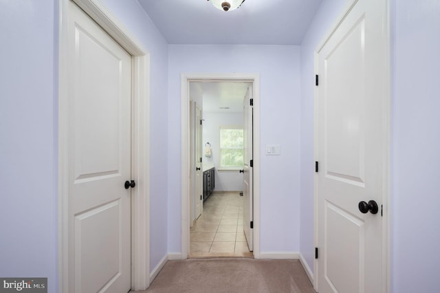 corridor featuring light tile patterned floors