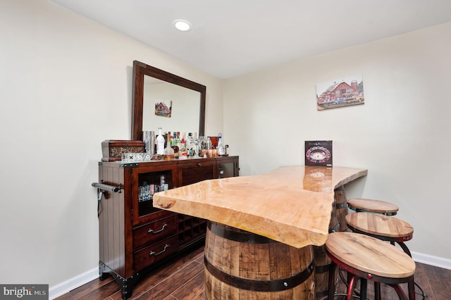 interior space featuring bar and dark hardwood / wood-style floors