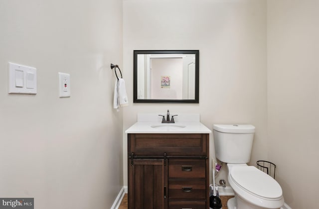 bathroom featuring vanity and toilet