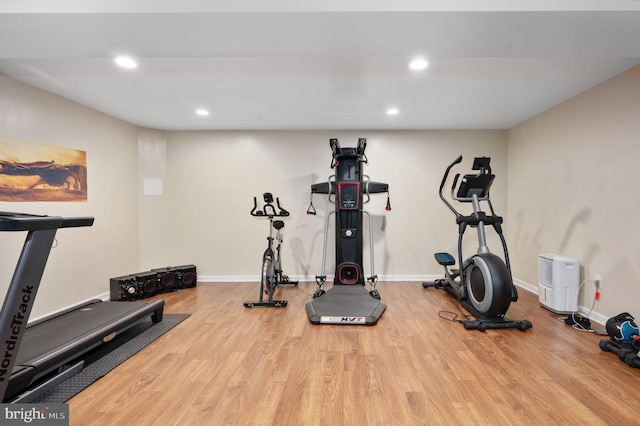 exercise room with light hardwood / wood-style floors