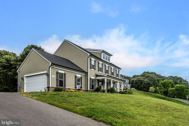 view of front of property featuring a front yard and a garage