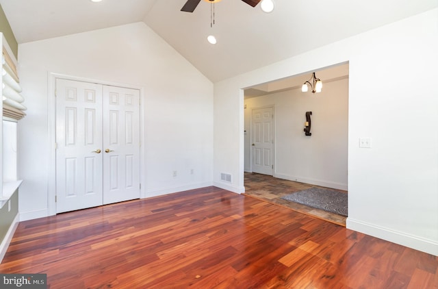 unfurnished room featuring high vaulted ceiling, dark hardwood / wood-style floors, and ceiling fan