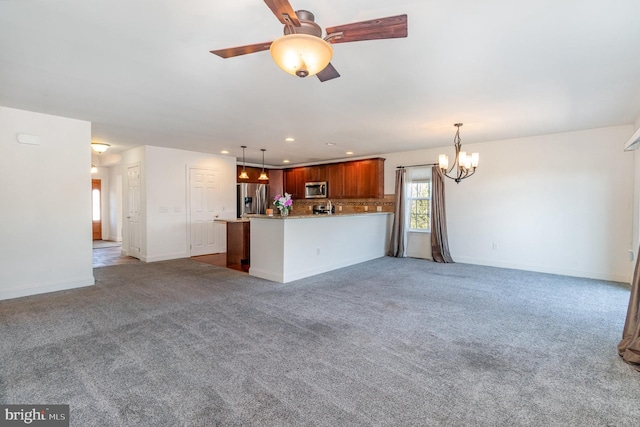 unfurnished living room with ceiling fan with notable chandelier and light carpet