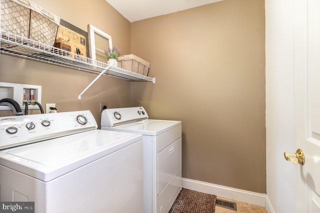 laundry area with tile patterned flooring and washer and dryer