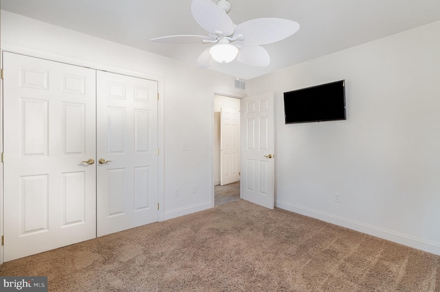 unfurnished bedroom featuring ceiling fan, carpet flooring, and a closet