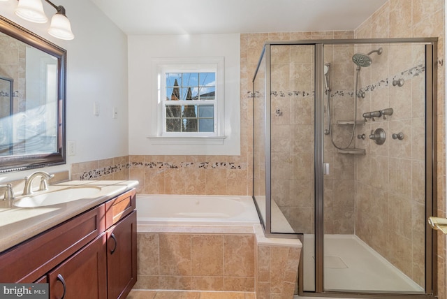 bathroom with vanity and separate shower and tub