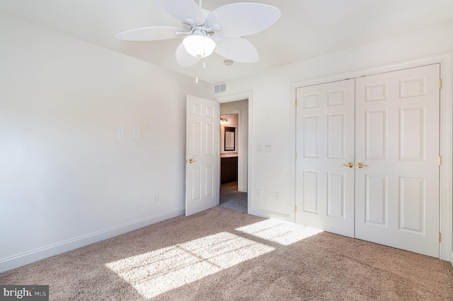 unfurnished bedroom with ceiling fan, carpet floors, and a closet