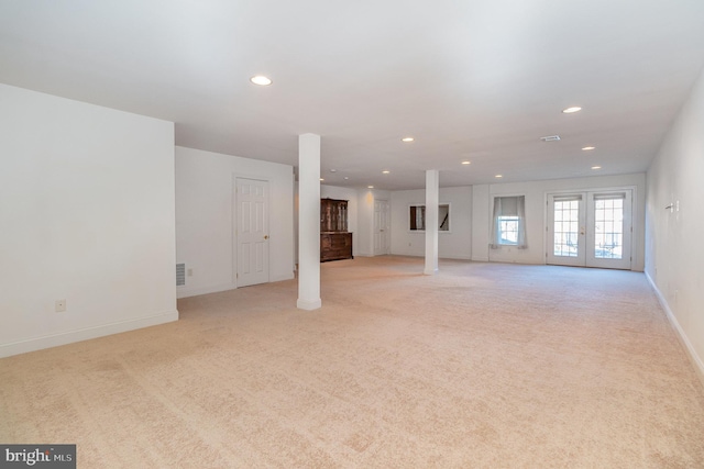 interior space with french doors and light colored carpet