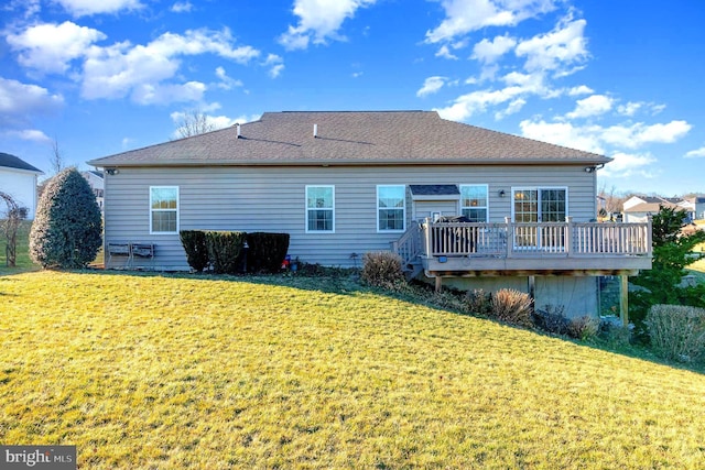 back of house featuring a wooden deck and a lawn