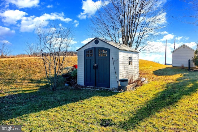 view of outbuilding featuring a lawn