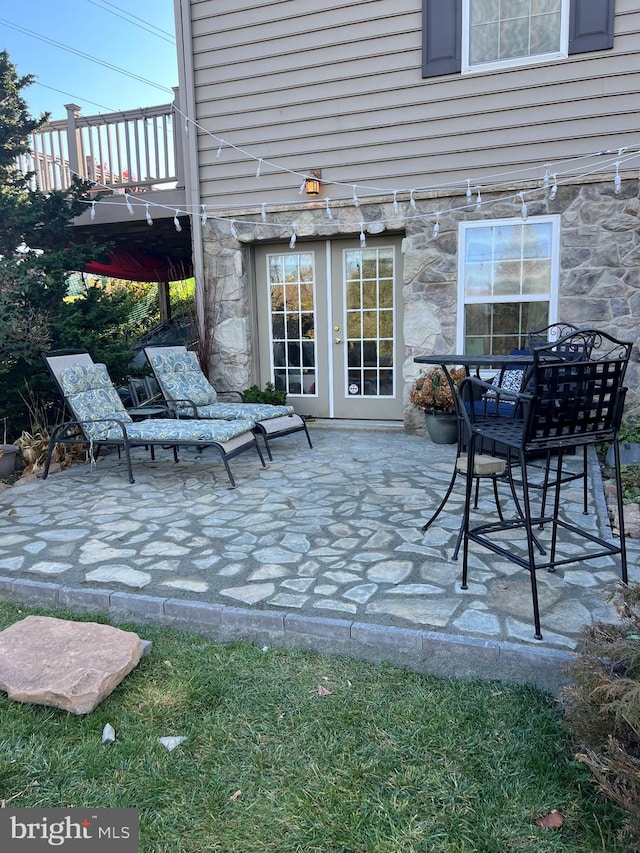 view of patio featuring french doors and a balcony