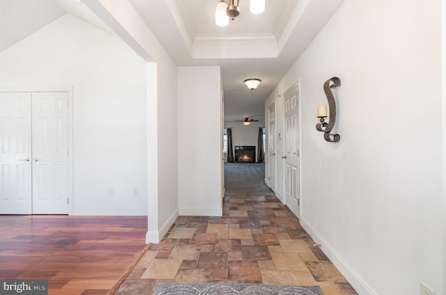 corridor featuring a tray ceiling and crown molding