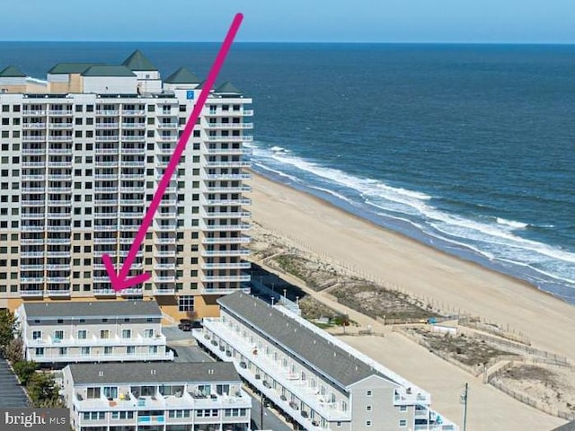 bird's eye view featuring a view of the beach and a water view