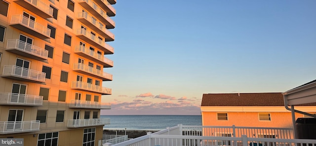 outdoor building at dusk featuring a water view