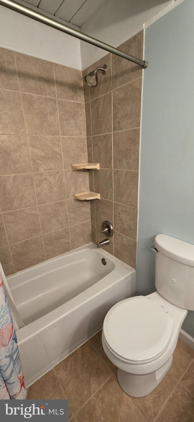 bathroom with toilet, shower / bath combo, and tile patterned floors