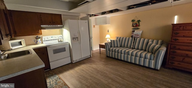 kitchen with sink, dark wood-type flooring, tasteful backsplash, extractor fan, and white appliances