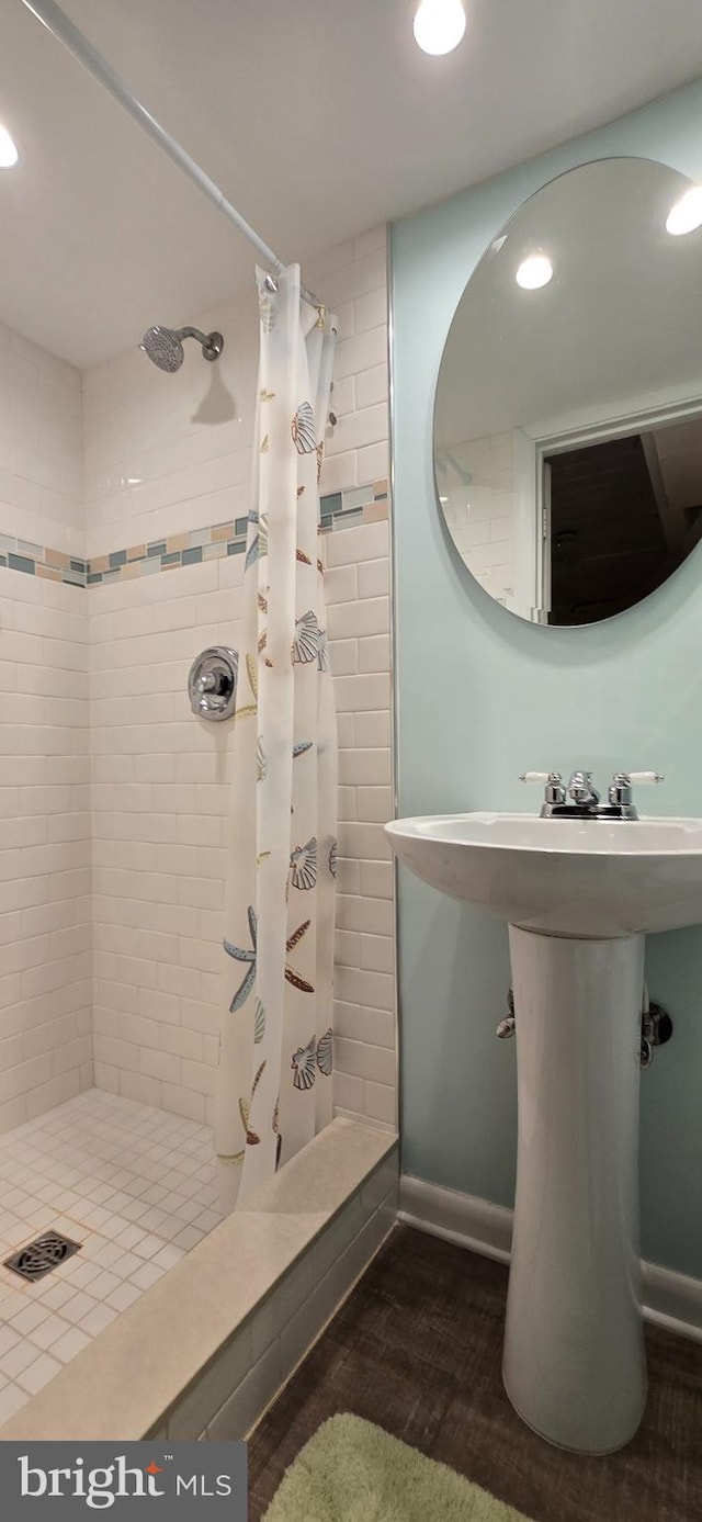 bathroom with wood-type flooring and a shower with curtain