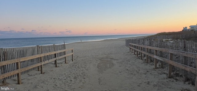 view of property's community with a beach view and a water view