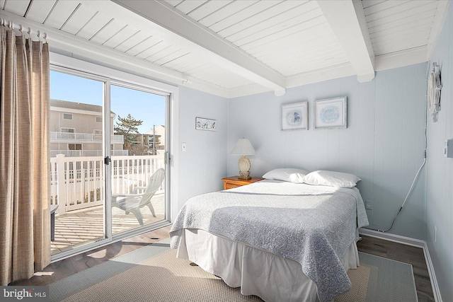 bedroom featuring hardwood / wood-style floors, beam ceiling, and access to exterior