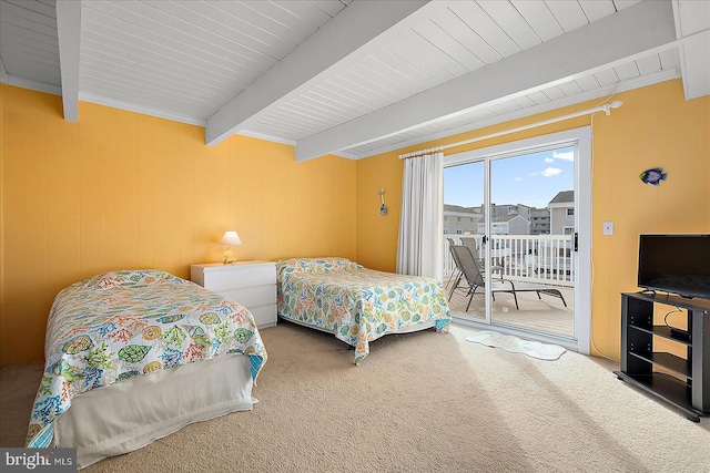 carpeted bedroom with beam ceiling and access to exterior