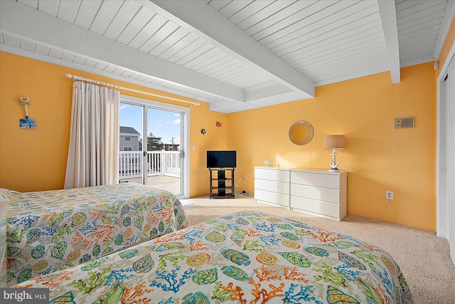 carpeted bedroom with beam ceiling and access to exterior