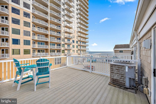 wooden terrace featuring cooling unit