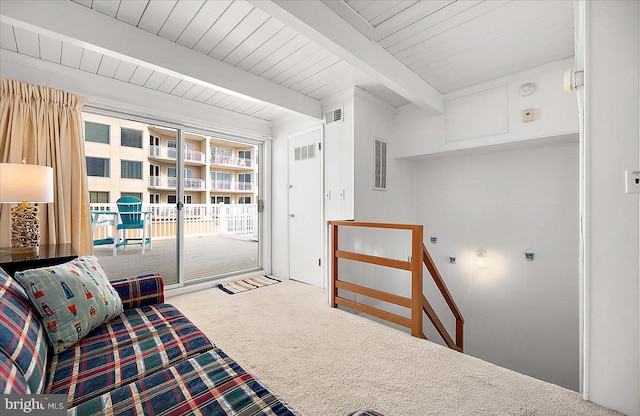 living area with beamed ceiling, carpet, and wood ceiling