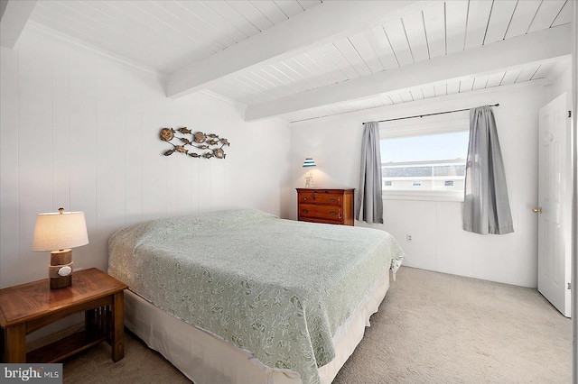 carpeted bedroom with beamed ceiling and wood ceiling