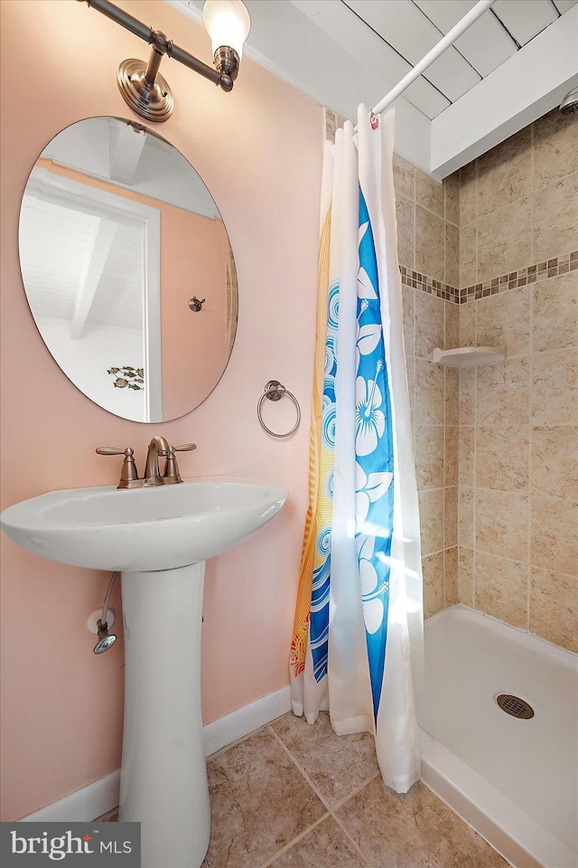 bathroom with tile patterned floors and curtained shower