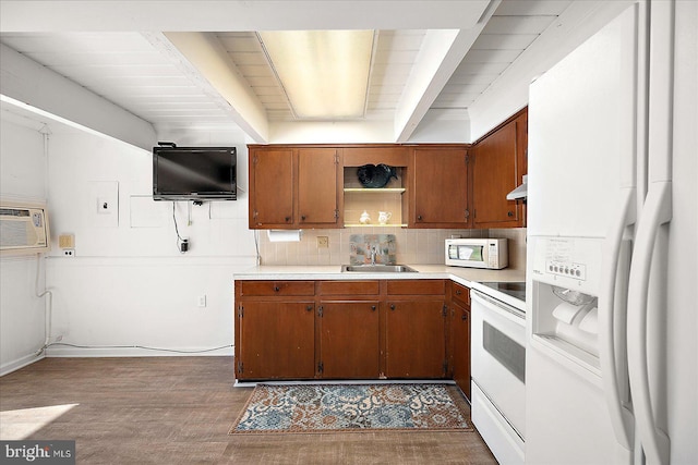 kitchen featuring backsplash, white appliances, ventilation hood, sink, and dark hardwood / wood-style floors