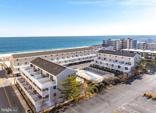 bird's eye view featuring a view of the beach and a water view