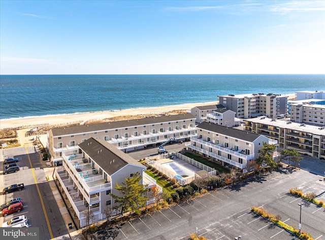 drone / aerial view with a water view and a beach view