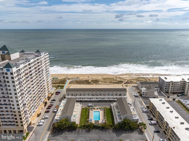 birds eye view of property featuring a water view and a view of the beach