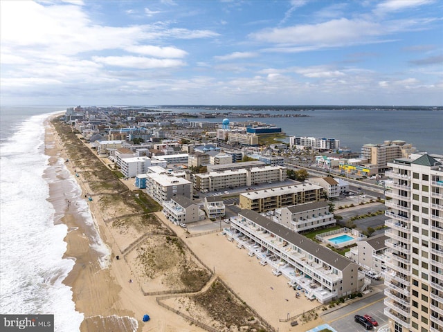 bird's eye view featuring a water view and a beach view