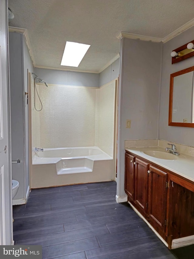 full bathroom with vanity, a textured ceiling, shower / bathing tub combination, hardwood / wood-style floors, and toilet