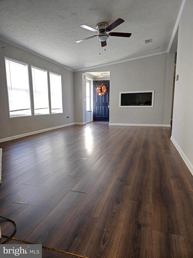 unfurnished living room with a textured ceiling, dark hardwood / wood-style flooring, and ornamental molding