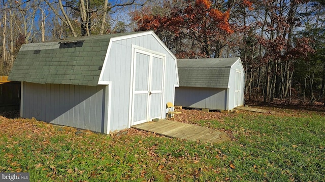 view of outbuilding featuring a yard