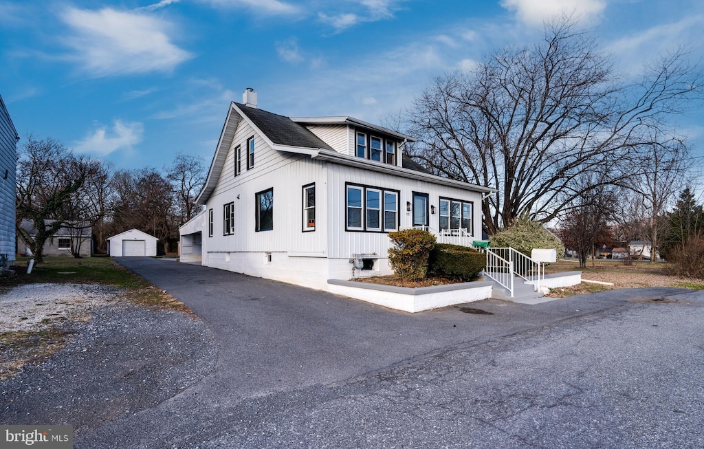 view of front of property featuring an outbuilding and a garage