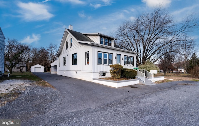 view of front of property featuring an outbuilding and a garage