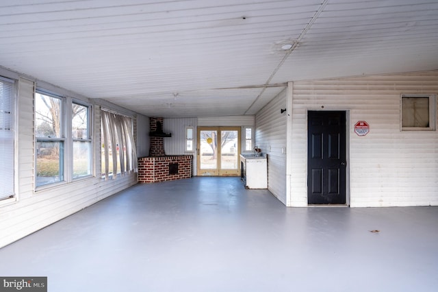 unfurnished sunroom with lofted ceiling