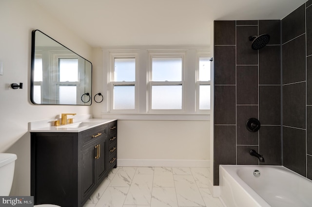 full bathroom with vanity, toilet, and tiled shower / bath