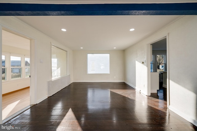 empty room featuring dark hardwood / wood-style flooring and crown molding