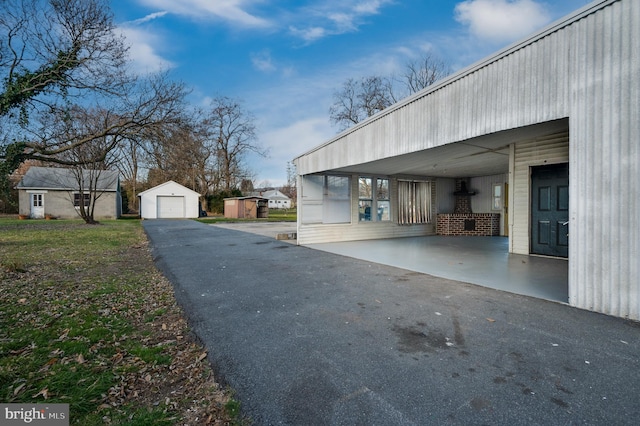 view of side of property featuring a garage and an outdoor structure