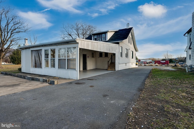 view of home's exterior with a carport