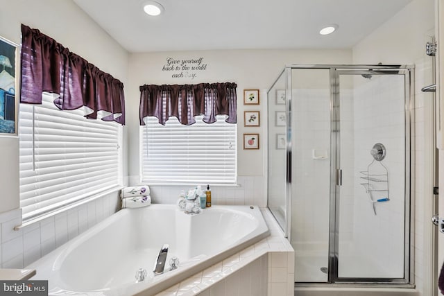 bathroom featuring independent shower and bath