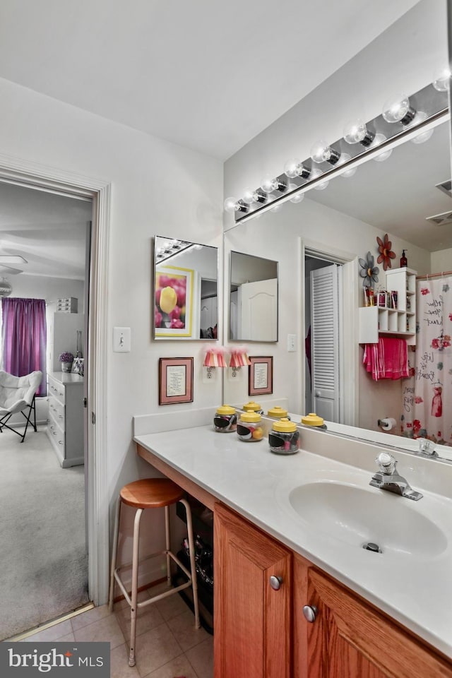 bathroom featuring tile patterned flooring and vanity